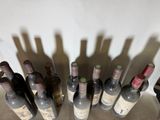 many bottles of wine that are sitting on a table