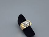 an image of a gold and diamond ring on a black velvet ring holder