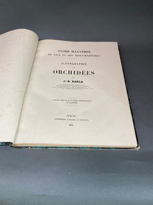 un livre ouvert posé sur une table à côté d'une tasse de café
