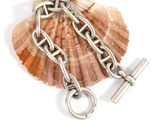 a shell with a chain attached to it and a pair of scissors