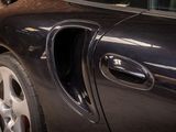an image of a car door handle with a cat sticking out of it ' s hole