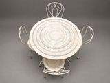 an image of a white table with four chairs and a basket on it