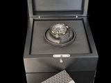 a close up of a box with a watch inside of it