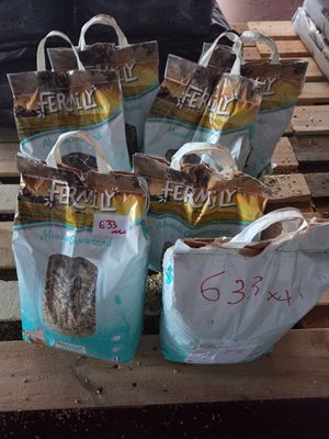 many bags of dog food on a pallet