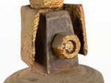 a metal bell with a gold decoration on top of it