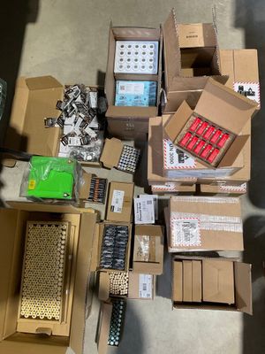many boxes of electronic devices and remotes on the floor