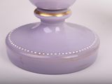 lavender colored vase with gold trim and beading around the base