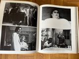 a book with pictures of people on it on the floor
