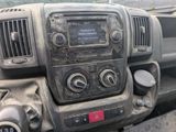 a dirty dashboard of a truck with a clock on it