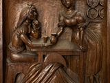 a statue of a woman and a man sitting at a table