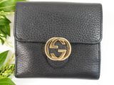a black leather wallet with a gold gucci logo on it