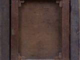 an old wooden picture frame hanging on the side of a wall