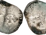 a silver coin with a crown on it and a cross on the front