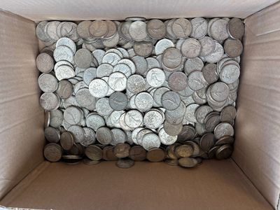 a cardboard box filled with lots of silver coins