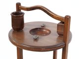 a small wooden table with a cup on top of it