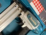 a stapler that is sitting on top of a blue case