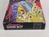 the box of the gameboy is sitting on a white surface