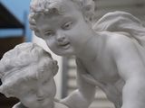 a statue of a boy and a girl that are looking at each other