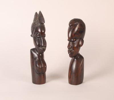 pair of carved wooden figures of a man and a woman