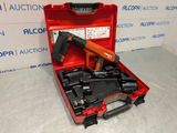 a red tool box with a nail gun and other tools in it