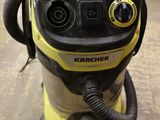 a yellow and black vacuum on the floor in a room