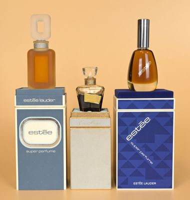 three bottles of perfume sitting on top of each other on a table