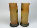 two tall vases that are sitting on a table