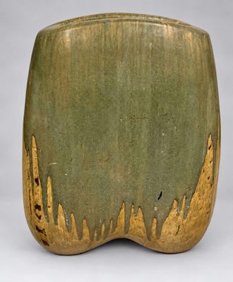 green and gold vase on white background with gray background