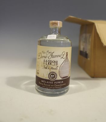 a bottle of alcohol sitting next to a cardboard box