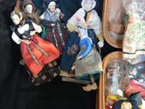 two suitcases filled with different types of figurines on a black cloth