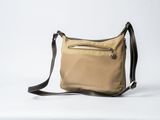beige and black shoulder bag on a white background