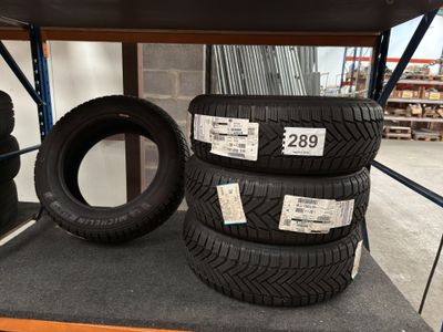 three tires are stacked on a shelf in a store