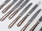 a lot of knives that are sitting on a table