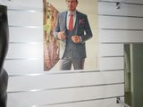 a picture of a man in a suit hanging on a wall
