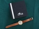 a close up of a watch and a book on a table