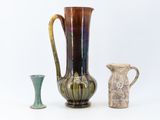 three vases sitting next to each other on a white surface