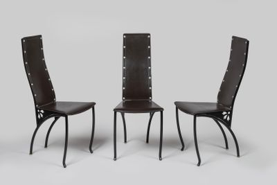 une paire de fauteuils en cuir noir avec des dossiers rivetés, sur fond blanc