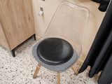 a chair that is sitting in front of a curtain