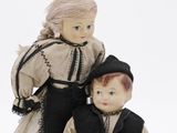 two dolls that are standing next to each other
