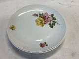 a plate with flowers on it sitting on a table