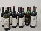 several bottles of wine are lined up on a counter