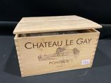 an old wooden box with a bottle of wine inside of it