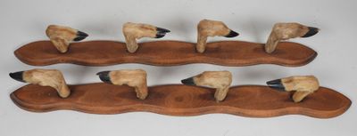 five sheep on a wooden stand with a white background