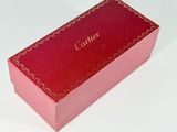 a red box with a name on it sitting on a white surface