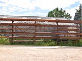 a wooden bench sitting in front of a brick building