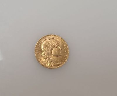 a close up of a gold coin on a white surface