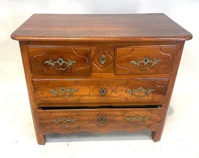 an image of a wooden chest of drawers with ornate carvings
