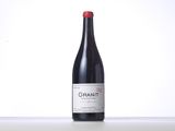 a close up of a bottle of red wine on a table