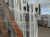 a pile of windows and a ladder in the back of a truck
