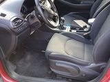 the interior of a red car with a steering wheel and dashboard